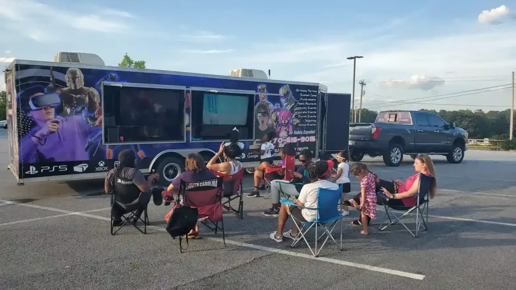 people outside the gaming truck watching movies