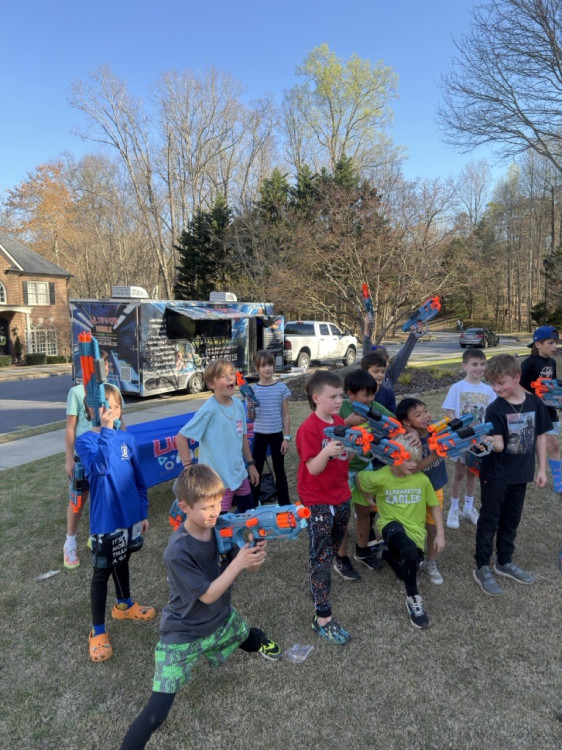 Friends in a backyard Nerf battle in Atlanta
