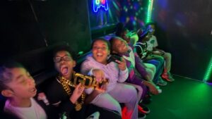 Students celebrating inside the Ultimate Mobile Gaming game truck during a group event